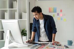 Creative Graphic Designer Working in Modern Design Studio with Digital Tools and Color Samples photo