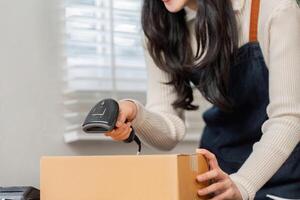 Woman utilizing a barcode scanner to efficiently deliver merchandise in a modern workspace photo