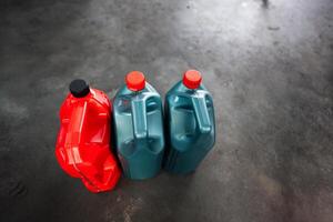 Plastic jugs with colorful caps on a concrete floor photo
