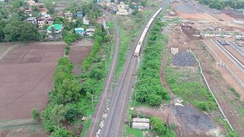 Drone overhead tracks winding through fields and dense foliage video