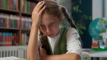 Suffering tired upset Caucasian little girl sad schoolgirl child school kid pupil learner student reading difficult task thinking hit her head hard homework schoolwork exam cognition problem indoors video