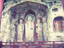 Ancient Buddha statues found inside caves by the side of the mountain sides photo