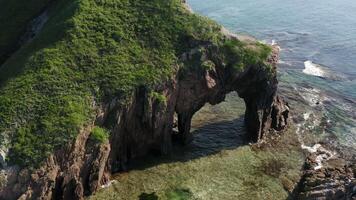 Drone view of a natural stone arch by the sea video