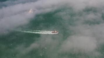 Aerial view of the a tugboat in motion in fog video