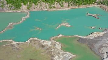 Drone view of the turquoise lake formed as a result of mining waste video