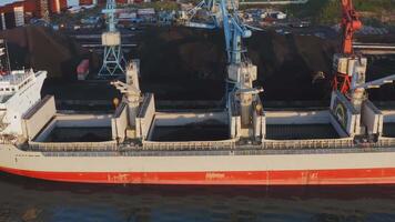 Sunrise supply chain. Drone view of port crane and coal handling video