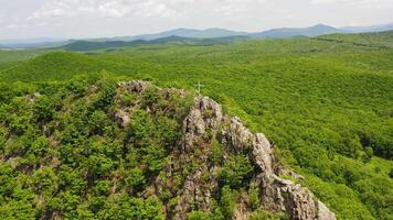 The cross is located at the top in the middle of a green valley video