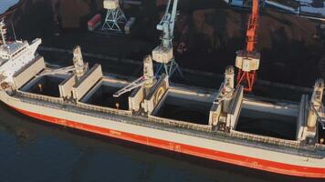 Loading and unloading. Drone view of port coal handling with crane video