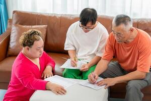Senior man and child practice math skill, interactive math game, Grandfather supervising grandchild sitting at sofa doing homework photo