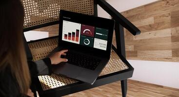 A person sitting on a chair with a laptop on it photo