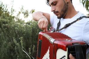Closing An Accordion At The End Of A Performance photo