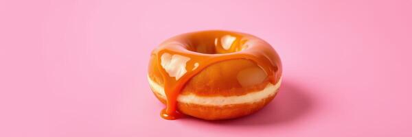 Delicious caramel glazed donut on a vibrant pink background showcasing its tempting texture and sweetness photo