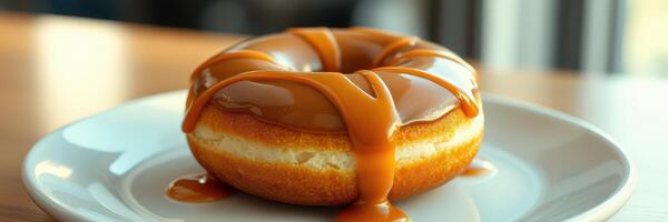 Delicious caramel topped donut served on a white plate with a soft focus background highlighting its sweetness photo