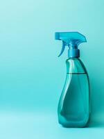 Cleaning spray bottle on turquoise background promoting hygiene and cleanliness photo