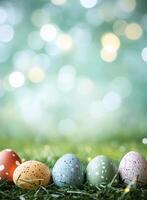 Colorful easter eggs lying on green grass with bokeh lights in background photo