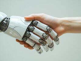 Human and robot shaking hands, collaboration between artificial intelligence and people photo
