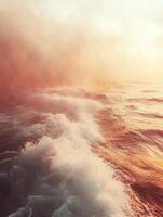 Ocean waves crashing at golden sunrise with fog photo
