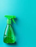 Cleaning spray bottle on turquoise background photo