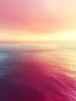 Vibrant pink and purple sunset illuminating calm waves photo