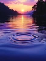 Vibrant purple sunrise reflecting on lake with gentle ripples photo