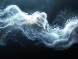 Blue smoke creating abstract shapes on black background photo