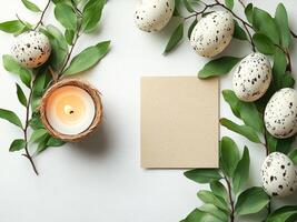 Easter eggs, candle and blank greeting card decorating a rustic wooden table photo