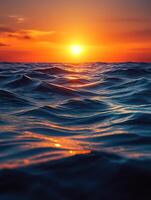 sunset reflecting on calm ocean waves at dusk photo