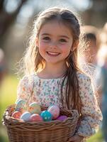 Smiling girl holding basket with easter eggs in spring garden photo