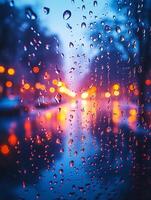 Rain drops flowing down window glass at sunset with blurred city lights photo