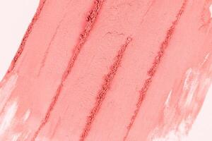 Beautiful parallel strokes of the cosmetic texture of pink blush. Abstract background of decorative cosmetics. texture of a dry blush in a pink tone photo