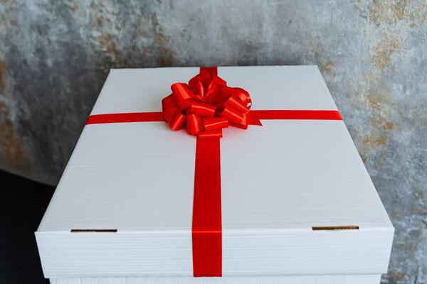 Rectangle white box with an electric blue ribbon and bow on it