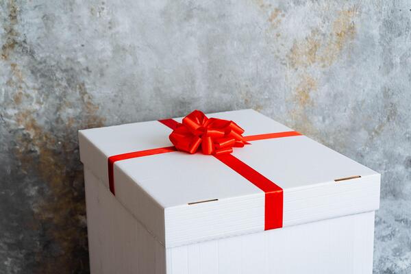 Rectangular wooden box with a red ribbon and bow, perfect for any event