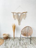 A furniture product, made of hardwood with a rectangular shape, placed on the floor next to a wall hanging. photo