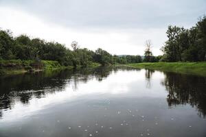 Picturesque and serene, this river landscape boasts lush greenery and calm waters, offering a tranquil environment in natures embrace for relaxation and reflection photo