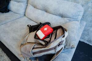 To get ready for a trip, a first aid kit is in a backpack, a tourist kit, equipment for the trip. photo