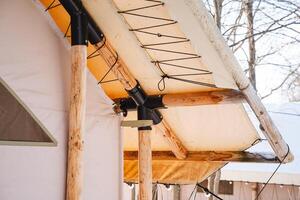 The upper section of the tent is constructed from robust wood and resilient canvas, providing outstanding structural support and dependable protection against various weather conditions photo
