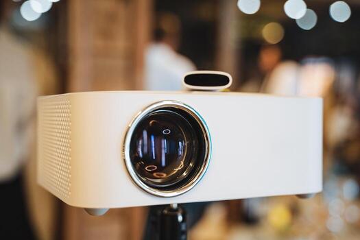 A modern white projector mounted on a stand, perfect for presentations and various events, enhancing visual communication in multimedia displays photo