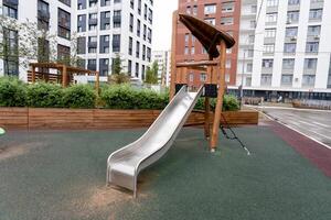 A contemporary playground slide designed for urban environments, featuring safety enhancements for children photo