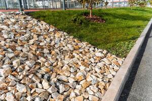 Explore the essential elements of landscape design, focusing on the contrast between rocks and lush grass in an urban environment photo