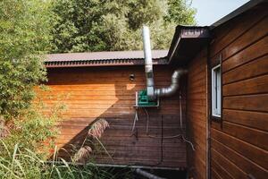 A charming wooden house, featuring a beautifully designed chimney, adds a delightful rustic charm and significant aesthetic appeal, elegantly situated within a stunning natural environment photo