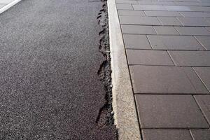 The damaged sidewalk resulting from significant ground movement has a notable impact on urban infrastructure photo