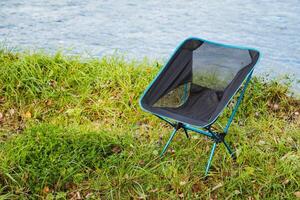 Experience the outdoors with a Compact Portable Camping Chair for ultimate comfort while relaxing by the river during your adventures photo