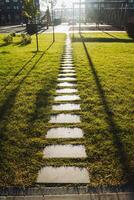 In a beautiful park, there is a charming row of stepping stones nestled in the lush green grass, inviting visitors to wander and explore the natural landscape surrounding them photo