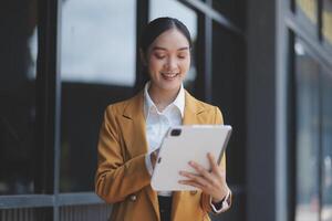 Businesswoman using digital tablet in modern office photo