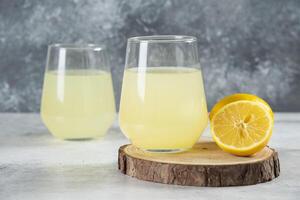 Two cups of tasty lemonade with lemon slices photo