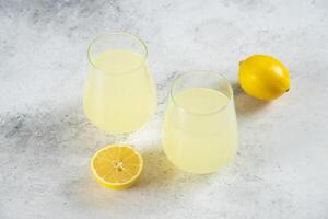 Two cups of lemonade with lemon slices photo