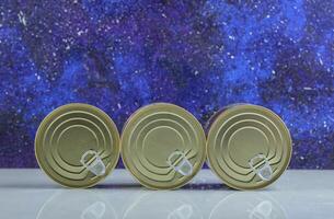Close up photo of closed tin can on blue background