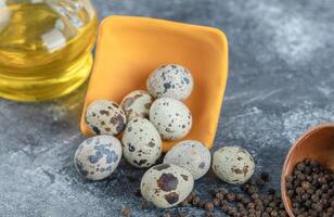 Pile of quail eggs on grey background photo