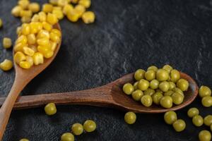 Canned corns seeds with green olives. photo