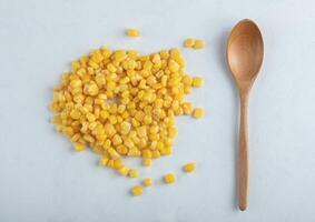 Canned sweet corn seeds on white background photo